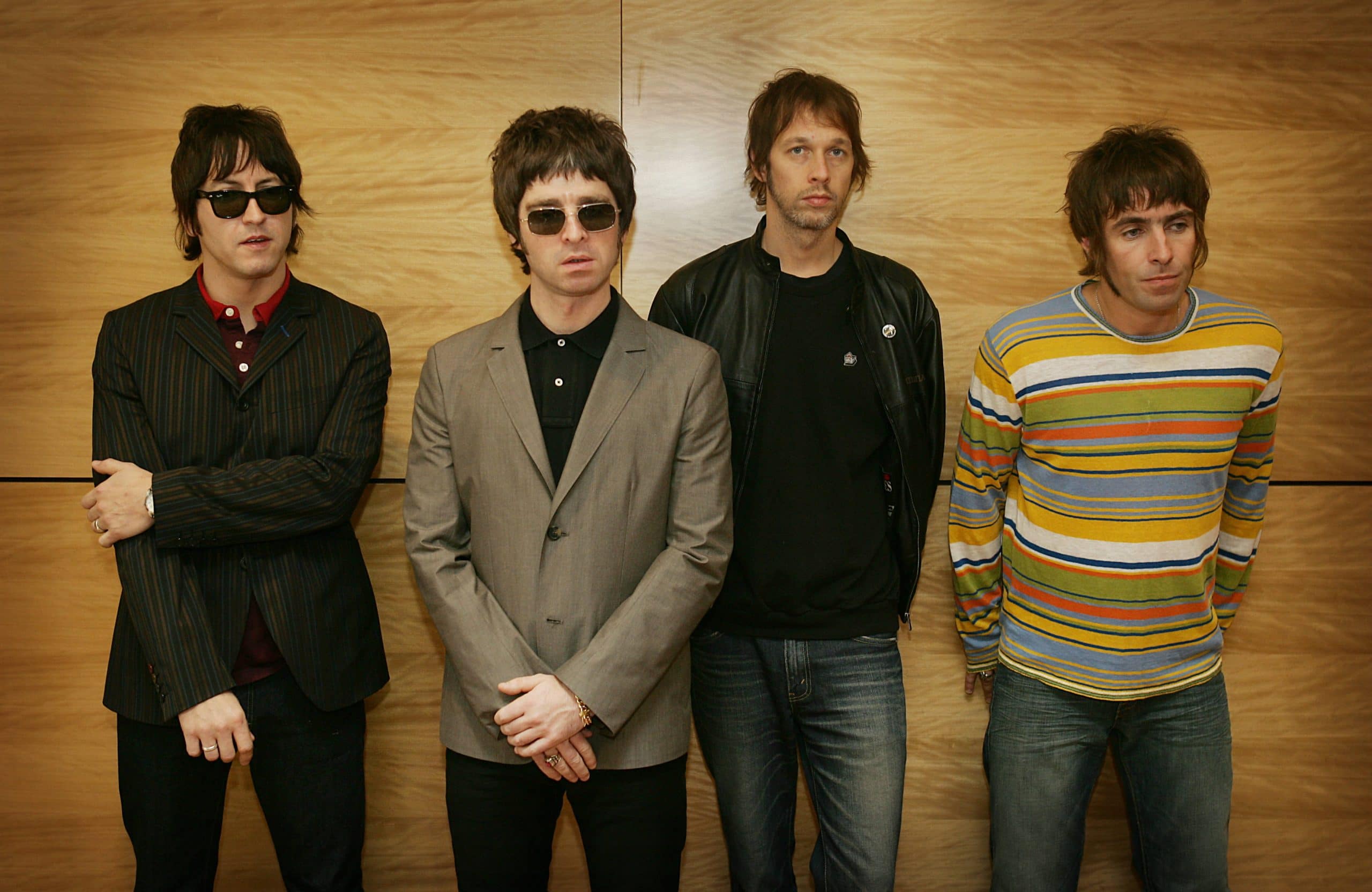 From L-R Gem, Noel Gallagher, Andy Bell and Liam Gallagher, members of the British rock band "Oasis" hold a photocall in Hong Kong 25 February 2006.  The Band are to hold a concert 25 February.      AFP PHOTO/MIKE CLARKE (Photo by MIKE CLARKE / AFP)